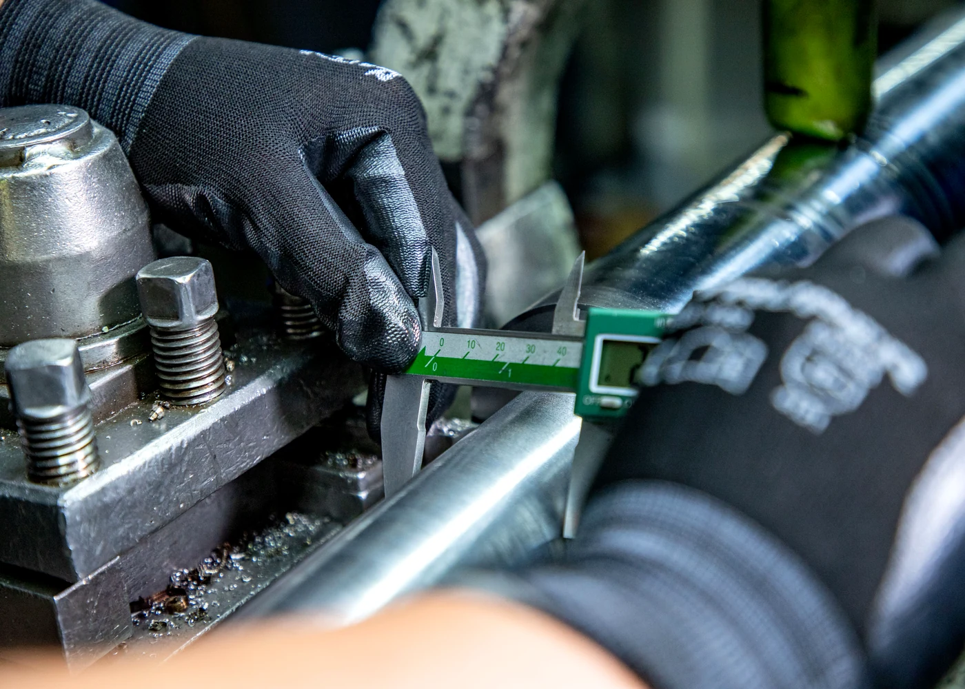 Technician verifying a metal component during material and specification review