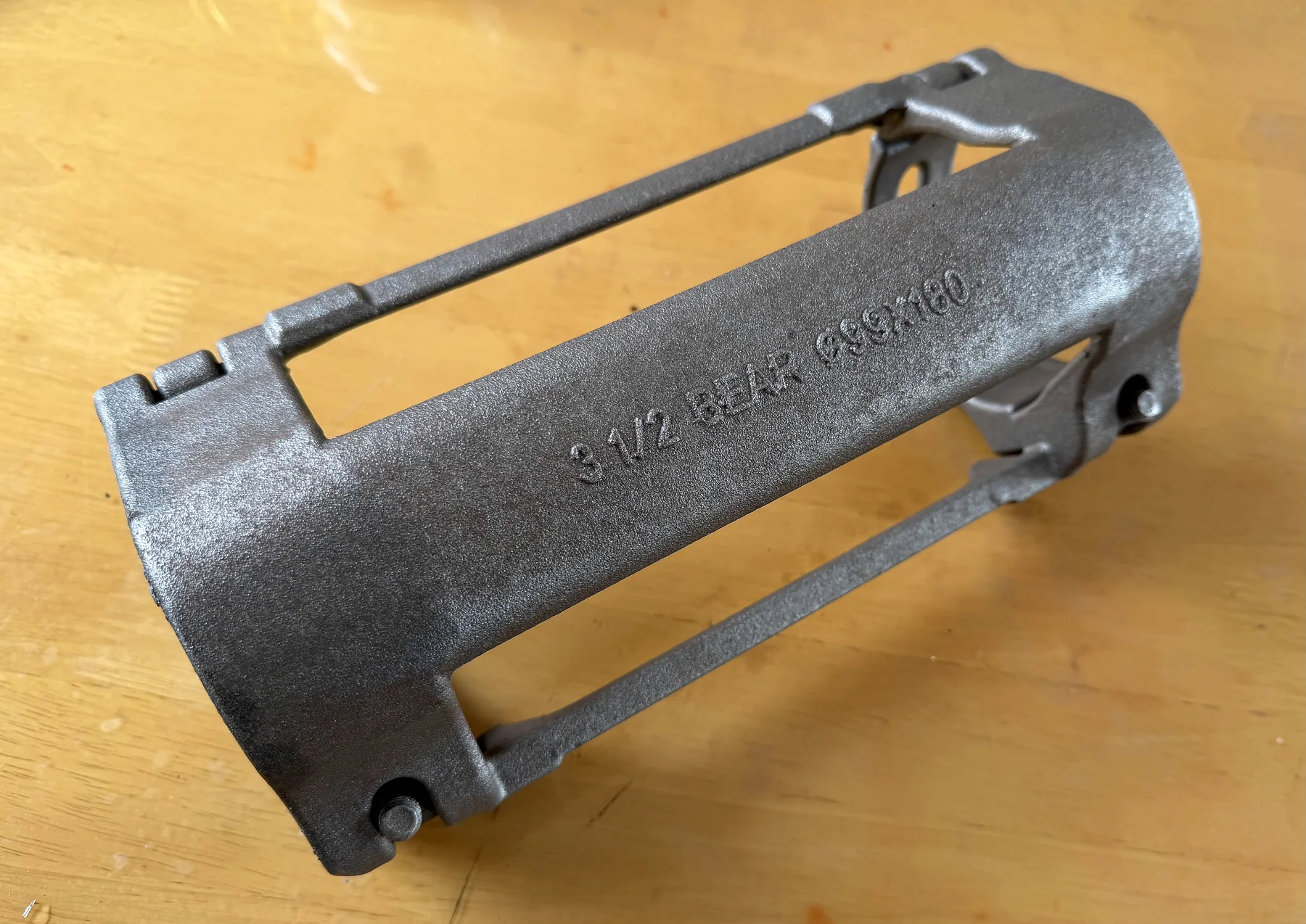 Cast oilfield cable protector body sample with raised size marking
